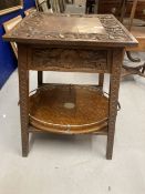 20th cent. Oak arts and crafts table carved floral relief the top opening to reveal storage.