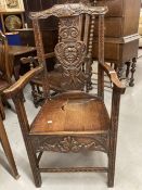 20th cent. Oak chair with heavily carved central back depicting a face with leaf decoration to top