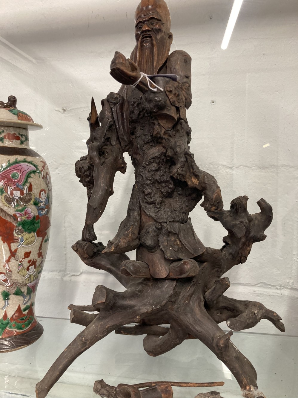 19th cent. Qing Dynasty carved rootwood figure of Shoulao shown standing holding a staff and a peach