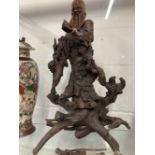 19th cent. Qing Dynasty carved rootwood figure of Shoulao shown standing holding a staff and a peach