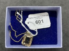 Jewellery: Yellow metal necklet with a rectangular citrine pendant attached, tests as 9ct gold.