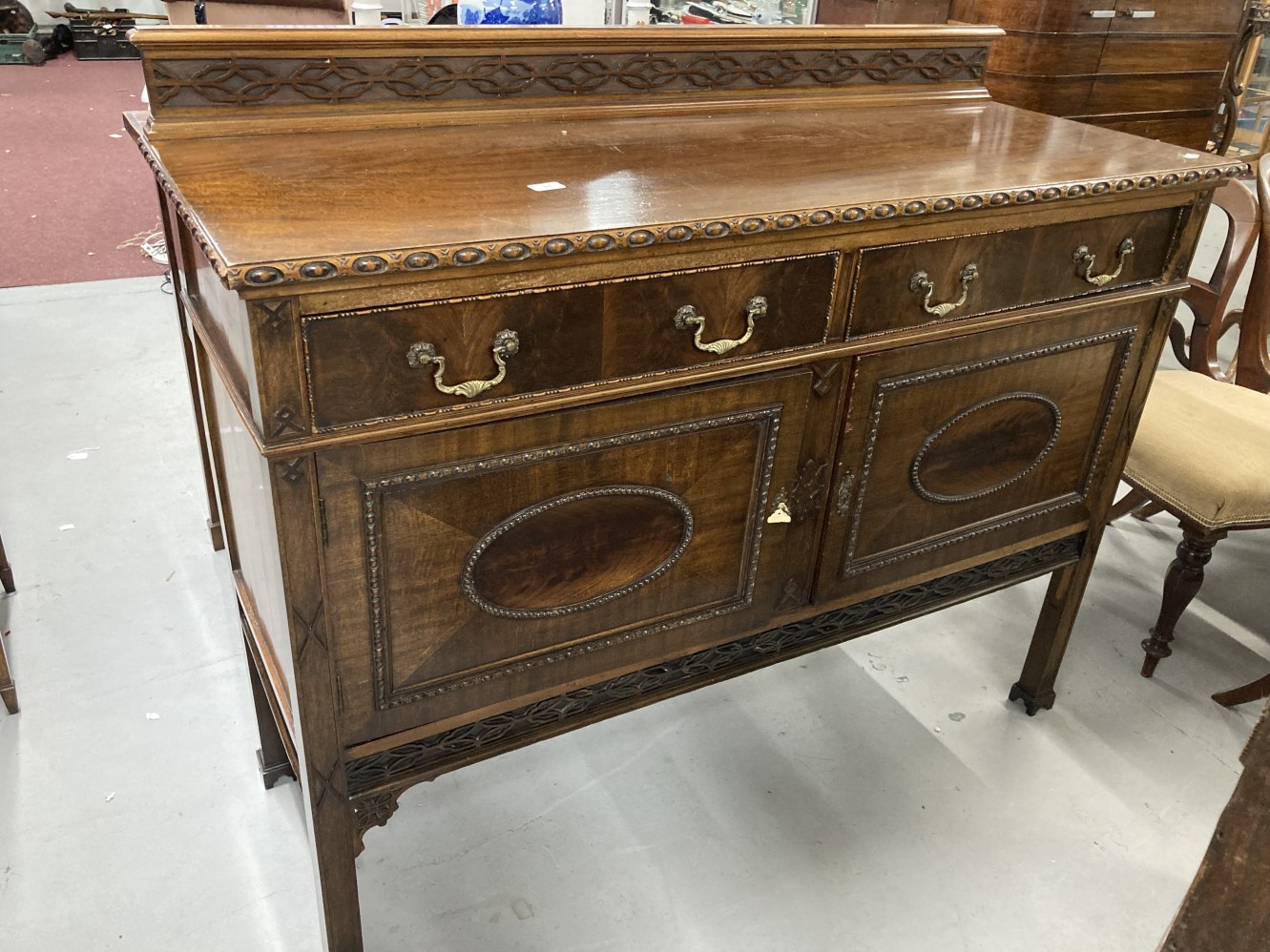 1920s mahogany sideboard two drawers above two cupboards decorated in the Jacobean style with