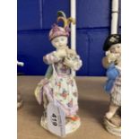 Meissen figures, young girl carrying a toy lamb decorated in coloured enamels, crossed swords to