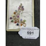 Jewellery: Yellow metal leaf spray brooch set with rubies, sapphires, tourmaline, citrine, garnets