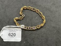 Jewellery: Yellow metal bracelet set with nineteen 6.5mm round cut amethysts, estimated weight of (