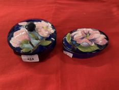 Moorcroft 'Magnolia' pattern boxes each decorated with blossoming magnolias on a blue ground,