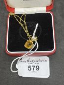 Jewellery: Yellow metal necklet with a rectangular cut citrine pendant attached, estimated weight