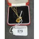 Jewellery: Yellow metal necklet with a rectangular cut citrine pendant attached, estimated weight