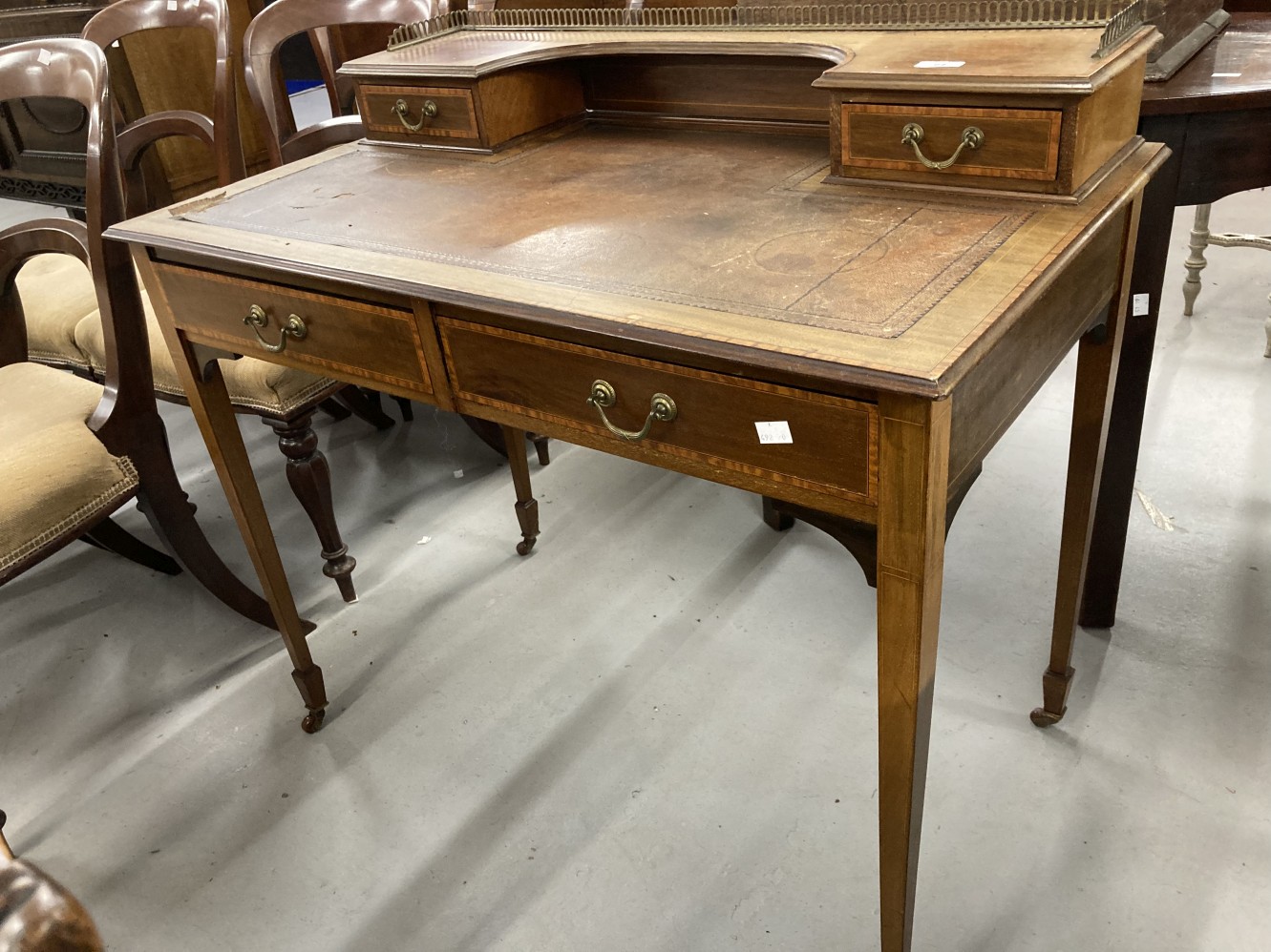 Edwardian mahogany writing desk with satinwood crossbanding and boxwood stringing, raised