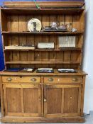 19th cent. Pine dresser the top with moulded cornice and three graduated shelves. The base with