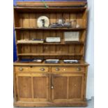 19th cent. Pine dresser the top with moulded cornice and three graduated shelves. The base with