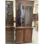 Early 20th cent. Mahogany two part bookcase, the thirteen pane glazed doors above two blind doors on