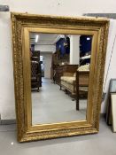 20th cent. Gilt mirror with moulded gesso frame. 47¼ins. x 35½ins.