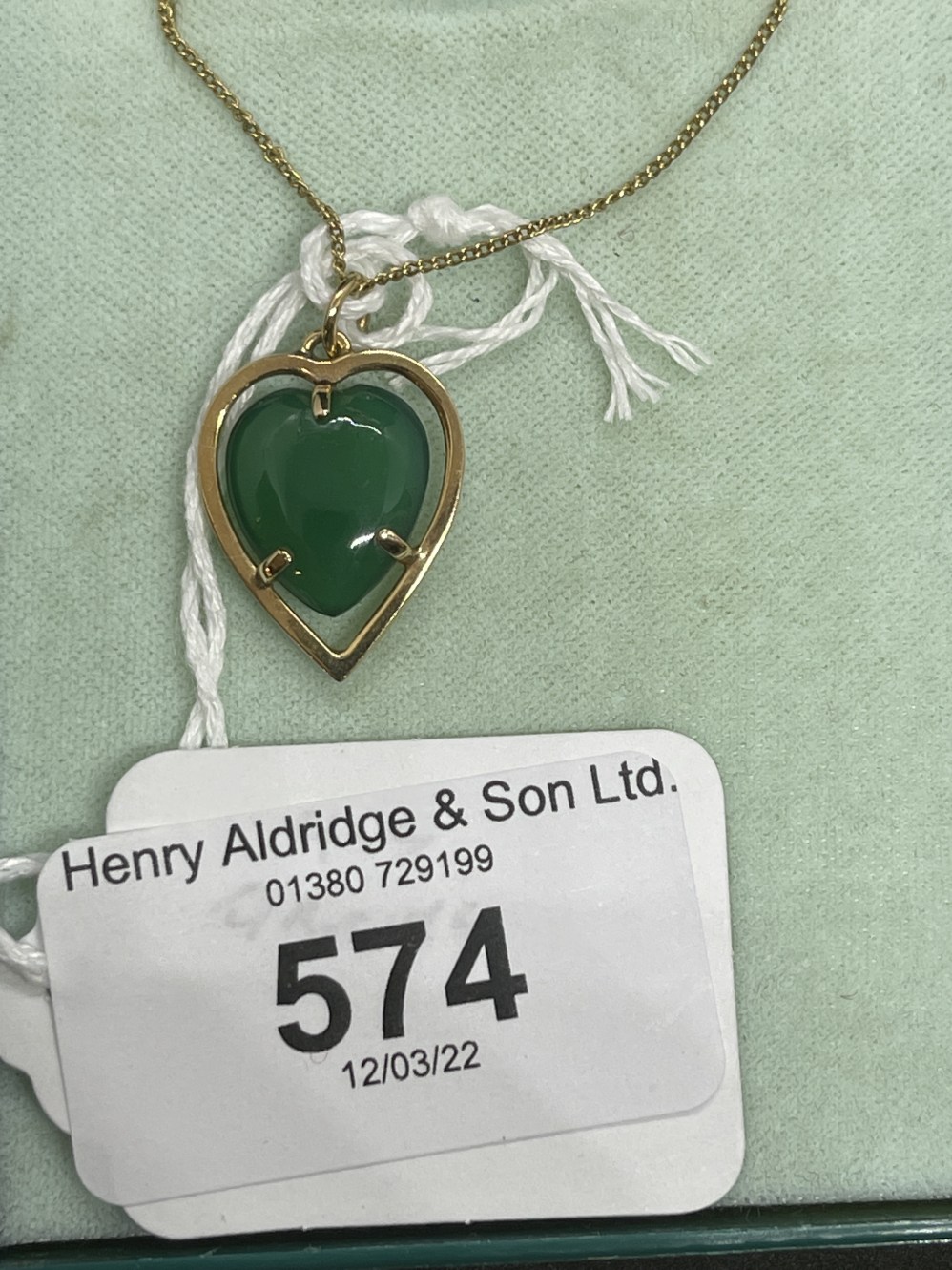 Jewellery: Yellow metal necklet with heart pendant attached set with a green agate, tests as 18ct