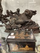 20th cent. Chinese hardwood carved water buffalo with two boys on its back, on stand. 1 horn A/F.