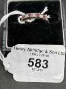 Jewellery: Yellow metal ring nine stone half hoop set with five circular cut rubies, estimated