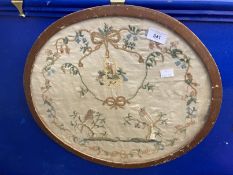 19th cent. Silk sampler depicting birds in trees surrounded by a laurel of rosebuds, forget-me-nots,