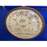 19th cent. Silk sampler depicting birds in trees surrounded by a laurel of rosebuds, forget-me-nots,