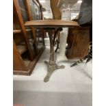 20th cent. Cast iron table with circular teak top and a black and gilt gypsy type table with