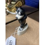 20th cent. Ceramics: Felix the cat kept on walking, on whit ceramic base. 4ins.