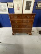 20th cent. Walnut and mahogany chest of drawers, cross banded top, two short drawers over three long
