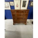 20th cent. Walnut and mahogany chest of drawers, cross banded top, two short drawers over three long