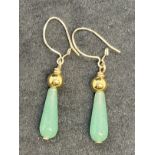 Jewellery: Yellow metal drop earrings each set with a pear shaped jade. Test as 18ct gold. Weight