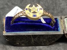 Jewellery: Yellow metal Victorian hinged bangle decorated on the head with a crescent moon and