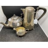 Hallmarked Silver:Art and crafts three piece tea set hammered finish base marked Searle & Co.