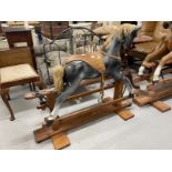 20th cent. Grey rocking horse with glass eyes, horsehair mane and tail on a pitch pine base.