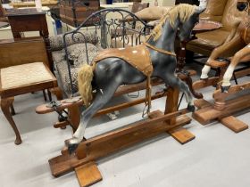 20th cent. Grey rocking horse with glass eyes, horsehair mane and tail on a pitch pine base.