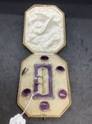 Hallmarked silver decorated with purple enamel buckle and buttons set. Total weight 49.5g.