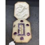 Hallmarked silver decorated with purple enamel buckle and buttons set. Total weight 49.5g.