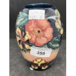 20th cent. Ceramics: Moorcroft ovoid shaped vase in the Honeysuckle pattern on pink and blue ground,