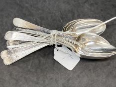 Hallmarked Silver: Twelve Georgian dessert spoons, mixed dates, bright cut pattern. Total weight 9.