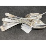 Hallmarked Silver: Twelve Georgian dessert spoons, mixed dates, bright cut pattern. Total weight 9.