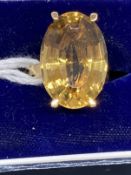 18ct gold ring set with an oval cut golden topaz, estimated weight of 9.00ct. Weight 8.2g.