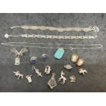 Jewellery: Collection of white metal jewellery to include charms, earrings, bracelets, etc. All test
