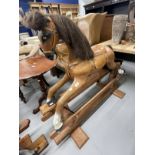 20th cent. Palamino rocking horse leather saddle on a pine base.