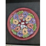 20th cent. Ceramics: Moorcroft plate in the Pansy pattern, on mauve ground. Appears to be a