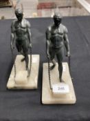 20th cent. Spelter bookends each with a bronze finish, figure of an athlete on an alabaster base.