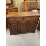 Early 20th cent. Hardwood cupboard with two drawers above a central panel flanked by two doors all