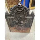 Cast iron fire back dated 1679, arched top, depicting angels working on the anvil. 31ins. x 23ins.