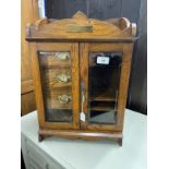 20th cent. Oak smokers companion glazed door, fitted interior of three drawers, pipe rack, storage