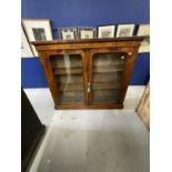 19th cent. Rosewood two door cupboard with glazed doors on a plinth base with two shelves. 48ins.