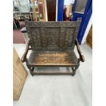 17th cent. Style oak settle with heavily carved decoration dated 1695 to the top rail. 39ins. x