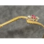 Hallmarked Jewellery: 9ct gold bangle set with a circular cut ruby, estimated weight 0.10ct, with