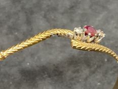 Hallmarked Jewellery: 9ct gold bangle set with a circular cut ruby, estimated weight 0.10ct, with