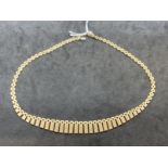 Hallmarked Jewellery: 9ct gold graduated fringe necklet. 16ins. Weight 23.6g.