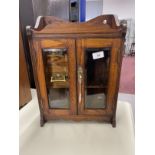 20th cent. Oak smokers companion glazed doors, fitted interior of two drawers, pipe rack, storage